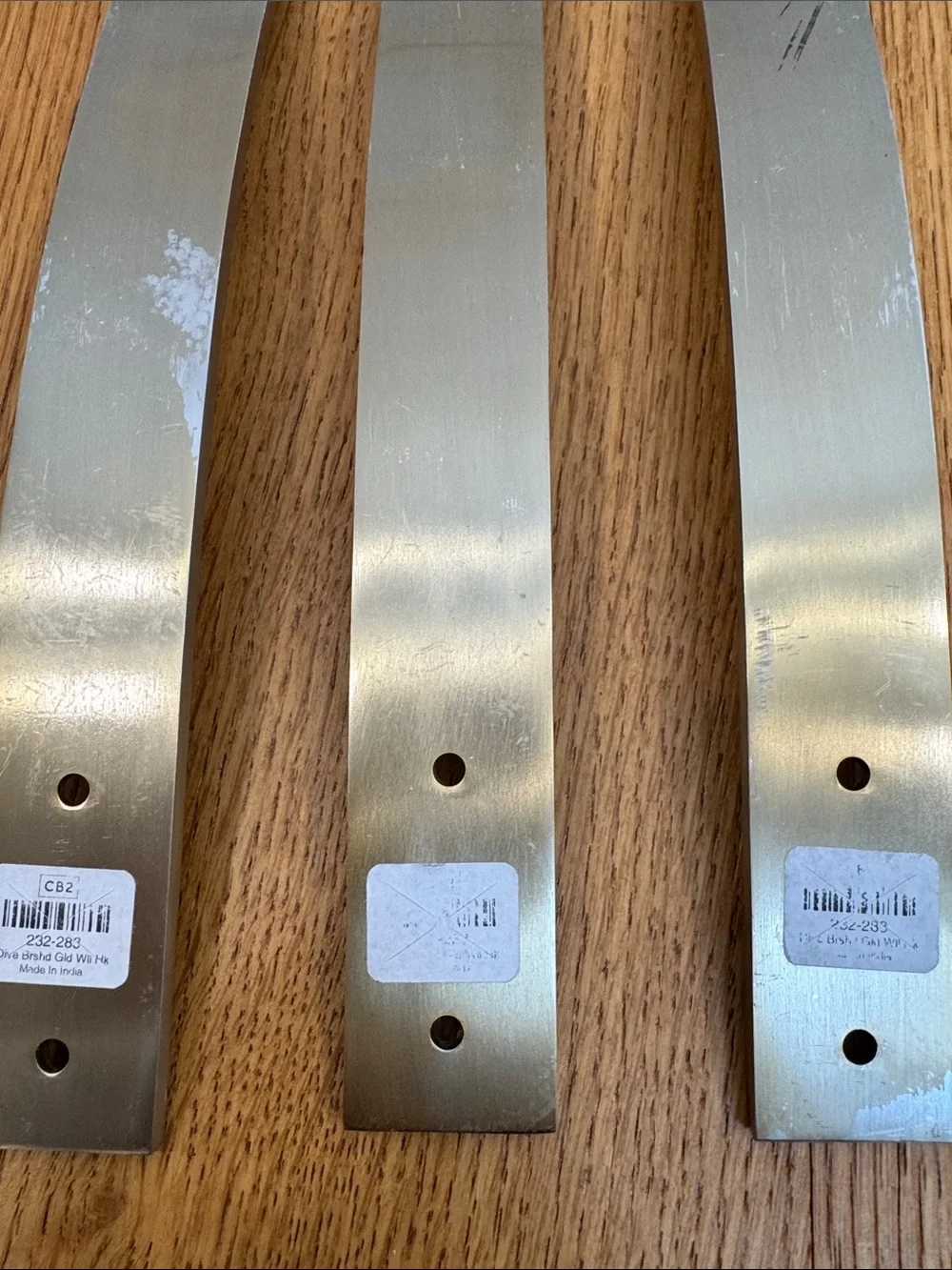 Set of 3 brushed gold Curved wall hangers CB2